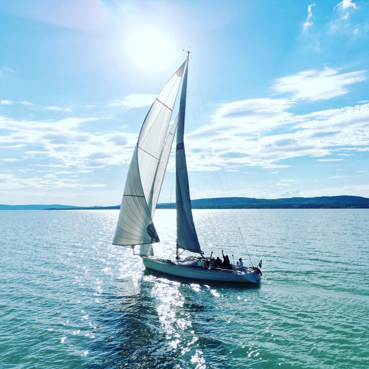 Guest aboard Jackpot with the Hungarian flag flying astern