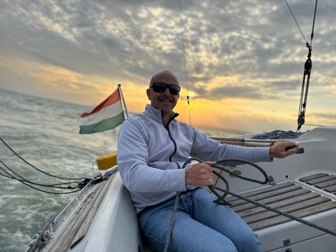 Szilárd Goda at the helm at sunset on Lake Balaton